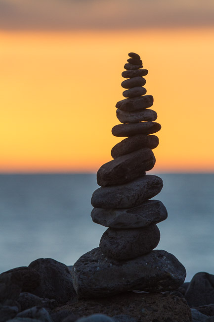 Pile of stones on beach at sunset, Adeje, Tenerife