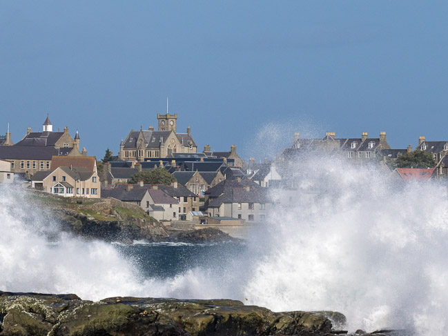 Breaking waves with central Lerwick in the background, Lerwick, Shetland
